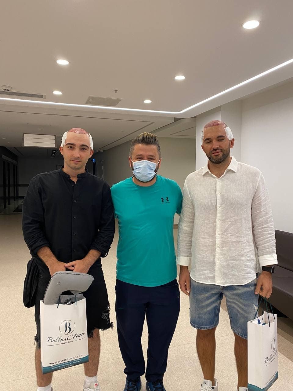 Hair transplant surgeon with his patients 